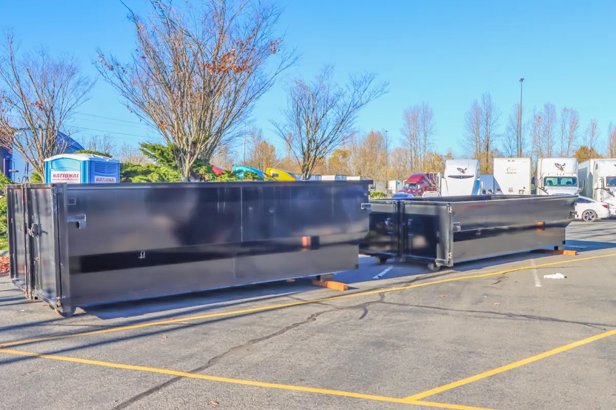 Professional dumpster rental service with roll-off container on residential driveway in Hopatcong